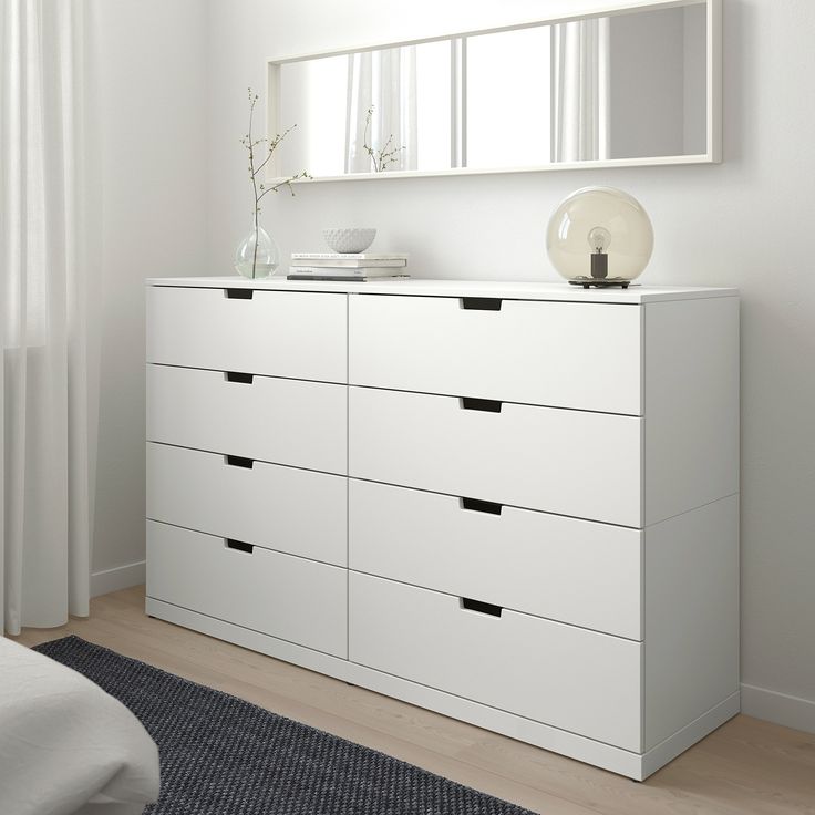 a white dresser and mirror in a room