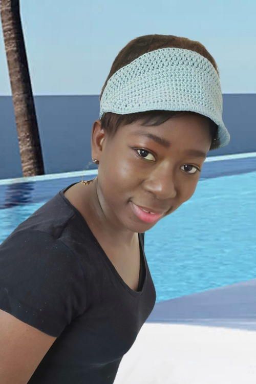 a woman standing in front of a swimming pool wearing a headband and looking at the camera