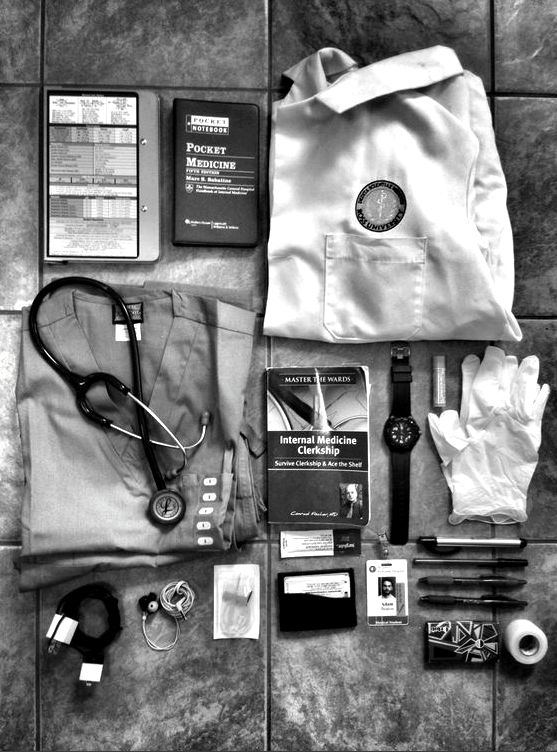 the contents of a doctor's bag laid out on top of a tile floor