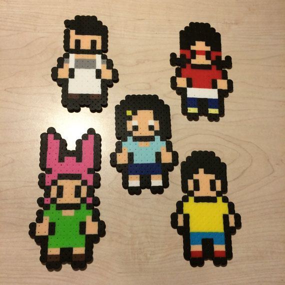 four pixel characters are shown on a wooden surface