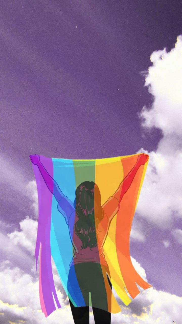 a woman holding a rainbow colored kite in front of a purple sky with white clouds