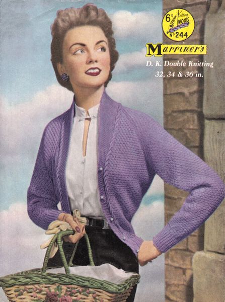 a woman in purple cardigan holding a basket