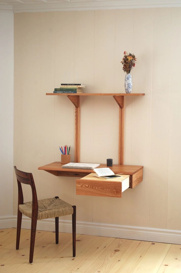 a wooden desk with a book shelf above it