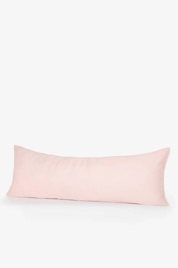 a pink pillow on a white background