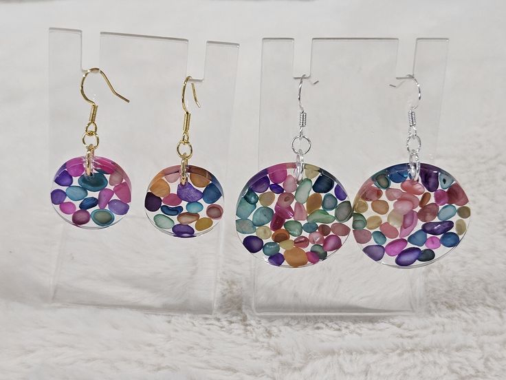 These handmade resin earrings are filled with multicolour sea shell stones. They are light and colourful. There are 2 sizes, 2cms and 3cms. You can also choose between gold and silver earring hooks. They are hypoallergenic and safe for sensitive ears. Multicolor Round Resin Earrings, Handmade Rainbow Round Earrings, Handmade Round Rainbow Earrings, Multicolor Resin Earrings For Pierced Ears, Multicolor Resin Round Jewelry, Multicolor Round Resin Jewelry, Rainbow Colorful Earrings For Gift, Handmade Rainbow Resin Jewelry, Handmade Colorful Circular Earrings