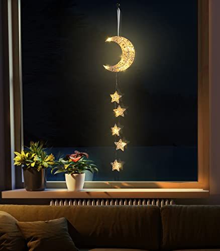 the moon and stars are hanging from the window sill