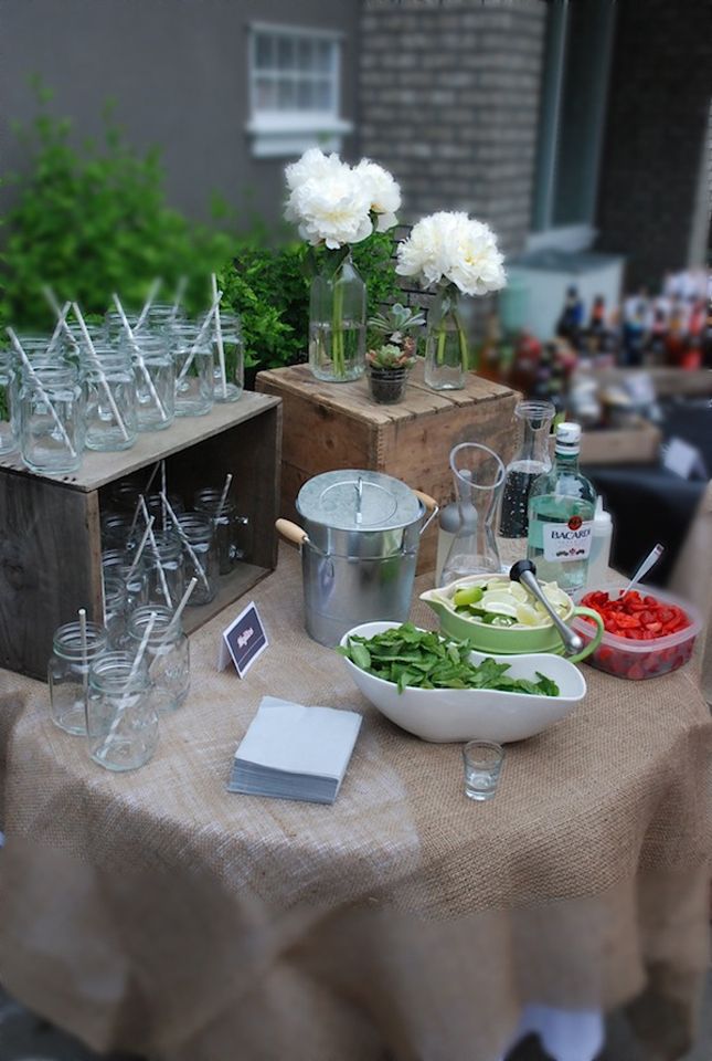 a table topped with lots of different types of food and drink glasses on top of it