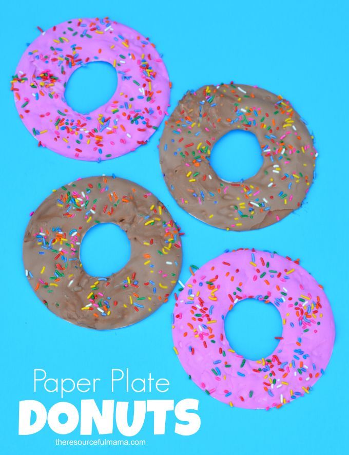 three doughnuts with sprinkles and chocolate frosting on blue background