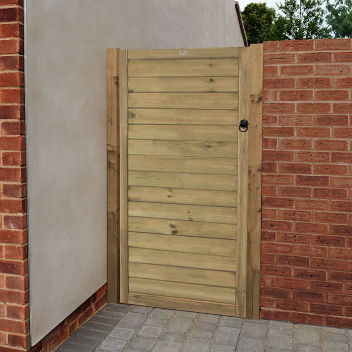 an open wooden door on the side of a brick building