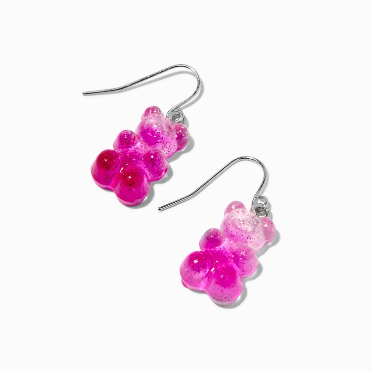 Look as cute and sweet as Gummy Bears® with these earrings! This pair of drop earrings has a pink, glittery Gummy Bears® design hanging from a fish-hook closure. Finish: Silver-tone Drop: 0.5 in. / 1.27 cm. Closure: Fish hook Material: Plastic - Claire's Pink Glitter Gummy Bears® 0.5" Drop Earrings Pink Resin Novelty Earrings, Novelty Pink Resin Jewelry, Playful Pink Resin Earrings, Cute Pink Glitter Earrings, Pink Novelty Dangle Jewelry, Trendy Pink Glitter Earrings, Nickel-free Pink Novelty Earrings, Novelty Pink Nickel-free Earrings, Pink Glitter Drop Earrings