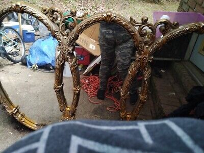 a person standing in front of a mirror on the ground with their feet propped up