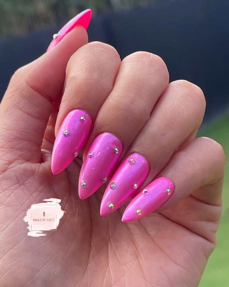 Colored Nails With Rhinestones, Hot Pink Nails With Gemstones, Barbie Pink Nails With Rhinestones, Hot Pink Nails With Diamonds Rhinestones, Pink Chrome Glitter Nails, Pink Metallic Almond Nails, Hot Pink Rhinestone Acrylic Nails, Hot Pink Nails With Pearls, Hot Pink Jeweled Nails