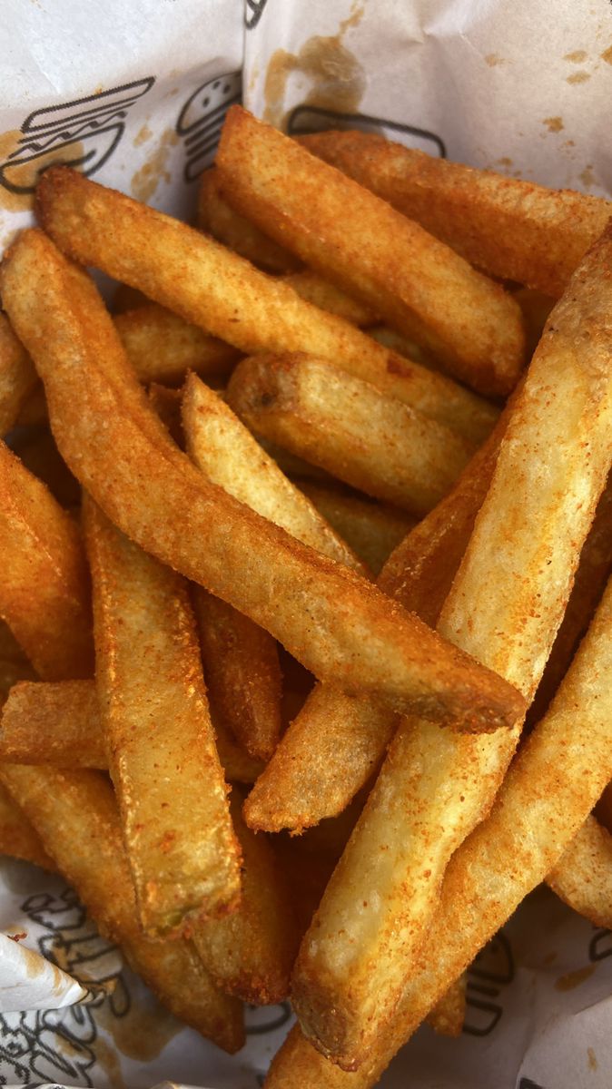 some french fries are in a basket on the table