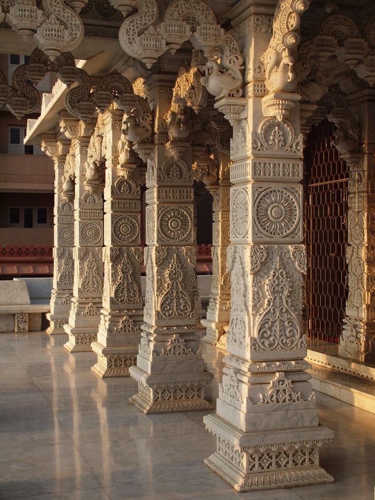 an intricately carved stone structure in the middle of a building with columns and arches