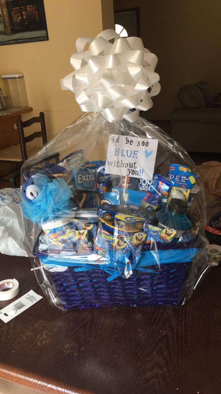 a blue basket filled with candy and candies sitting on top of a wooden table