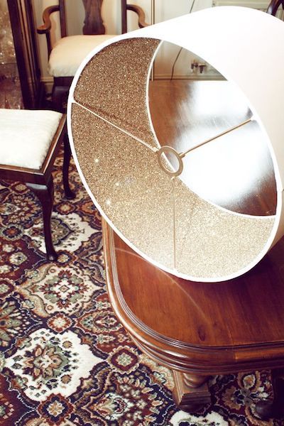 a wooden table topped with a mirror on top of a rug next to a chair