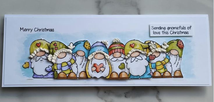 a handmade christmas card with five gnomes