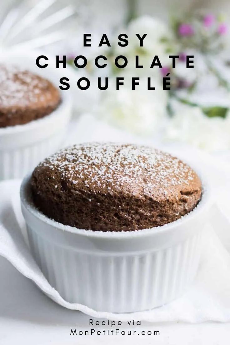 two chocolate souffles sitting on top of a white plate with flowers in the background