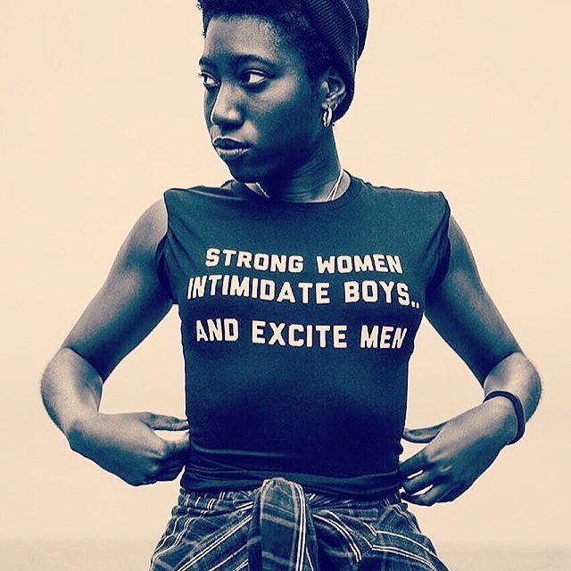 a woman wearing a t - shirt that says strong women intimate boys and excite men