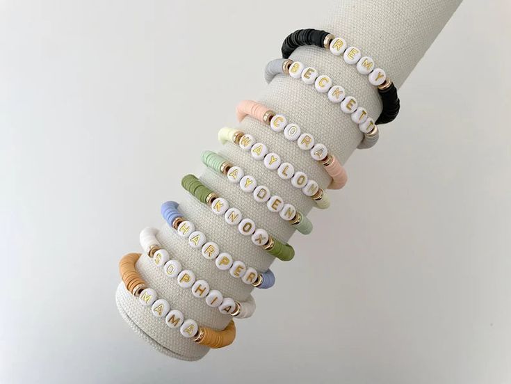 one heishi beaded name bracelet bracelets are made on a durable stretch elastic cord please refer to our sizing guide before purchasing Everyday Stacked Stretch Bracelet With Round Beads, Adjustable Stacked Beaded Bracelets For Everyday, Everyday Adjustable Stackable Stretch Bracelet, Casual Everyday Heishi Beads Friendship Bracelets, Casual Stacked Stretch Bracelet For Everyday, Casual Stacked Adjustable Stretch Bracelet, Casual Adjustable Stacked Stretch Bracelet, Trendy Stretch Bracelet With Letter And Heishi Beads, Adjustable Everyday Bracelets With Letter Beads