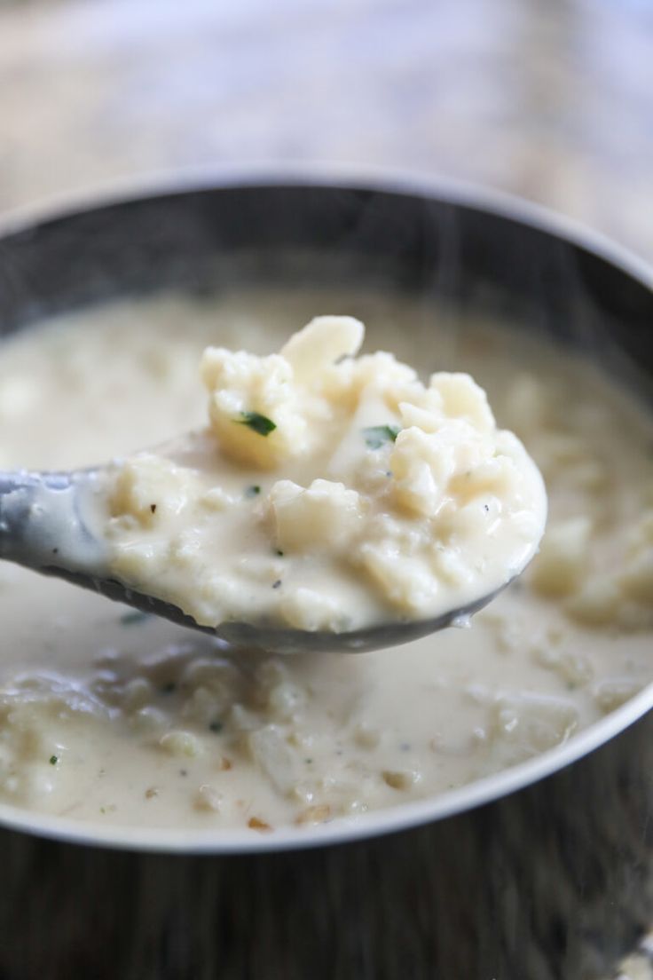 a spoon full of mashed potatoes and broth