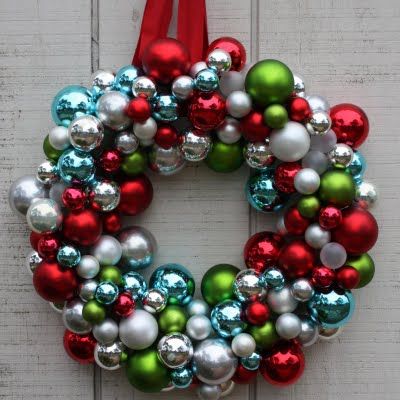 a christmas wreath with ornaments hanging from it