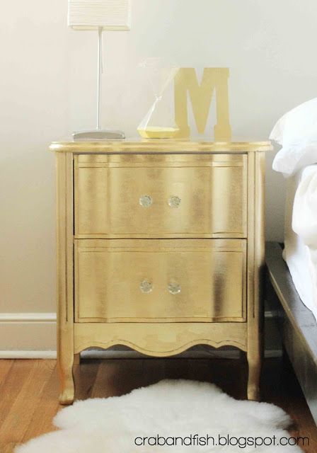 a gold dresser with two bottles on top