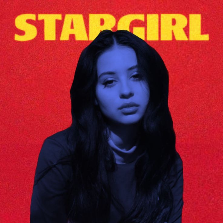 a woman with long black hair standing in front of a red and yellow background that says stargirl