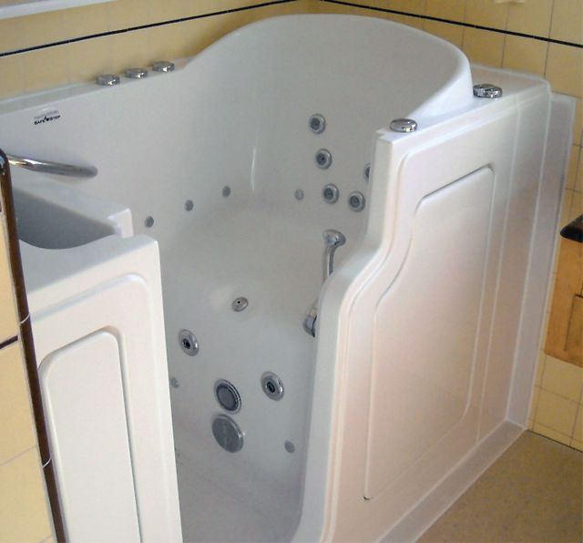 a large white bath tub sitting inside of a bathroom