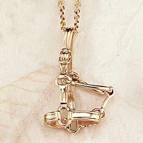 a gold necklace with a horse on it