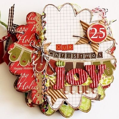 a close up of a clock made out of scrapbook pages and paper with the number 25 on it