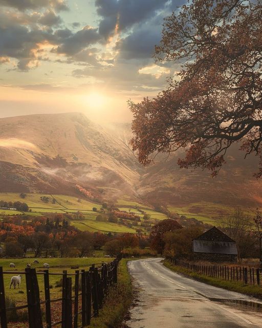 a rural country road in the mountains at sunset