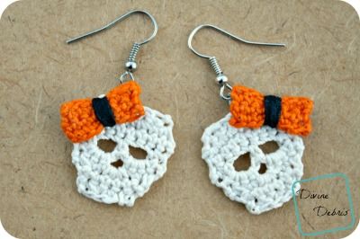 crocheted skull earrings with orange bows