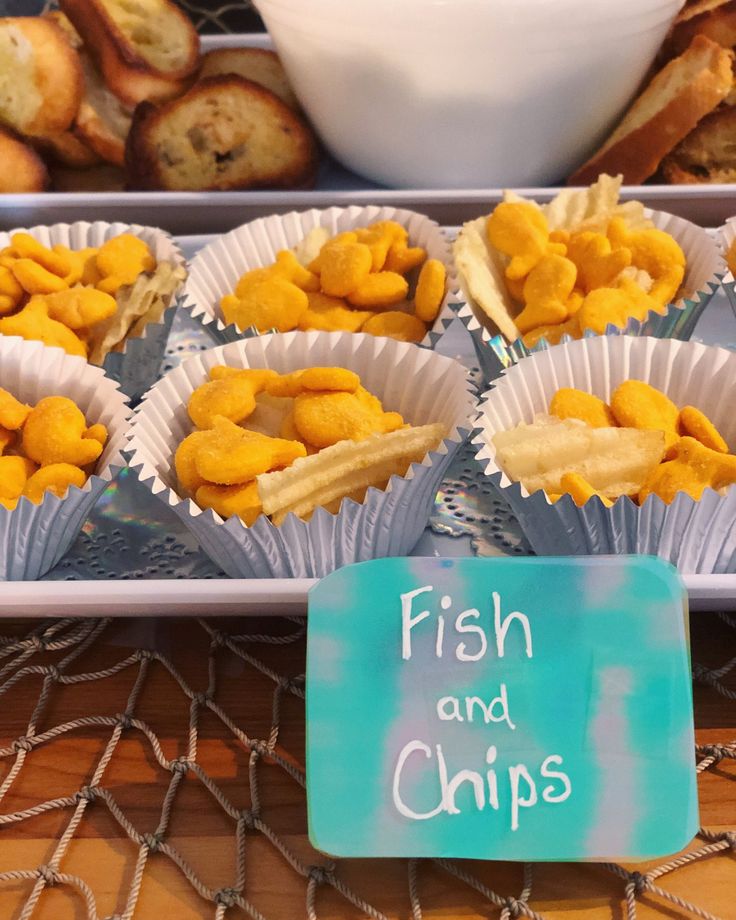 fish and chips are displayed in paper cups