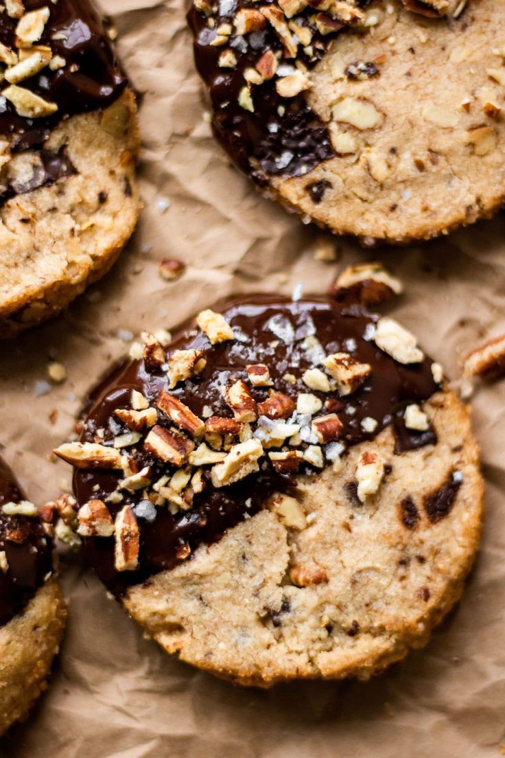 several cookies with chocolate and nuts on top