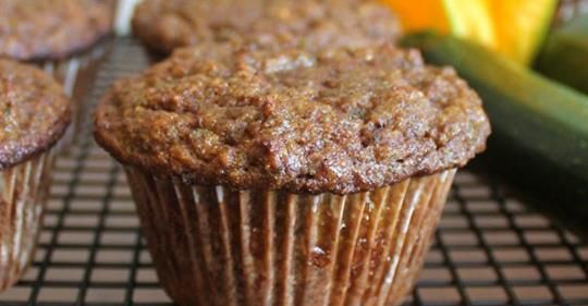 three muffins sitting on top of a cooling rack next to cucumbers