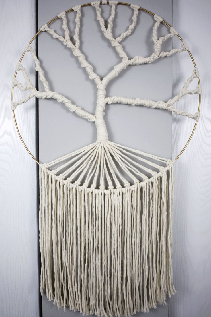 a white wall hanging with a tree on it