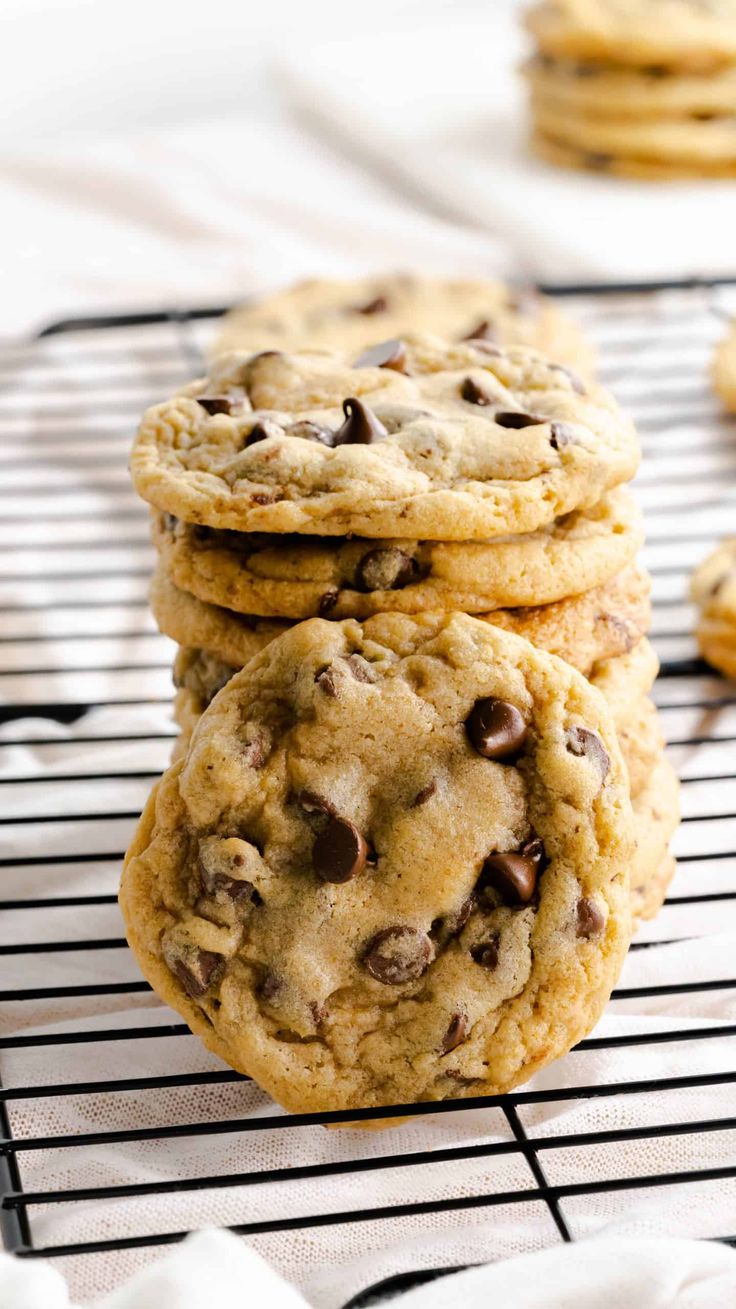 three chocolate chip cookies stacked on top of each other with text overlay that reads mrs fields'chocolate chip cookies copycat