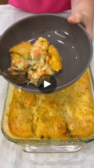 a person scooping food out of a casserole dish