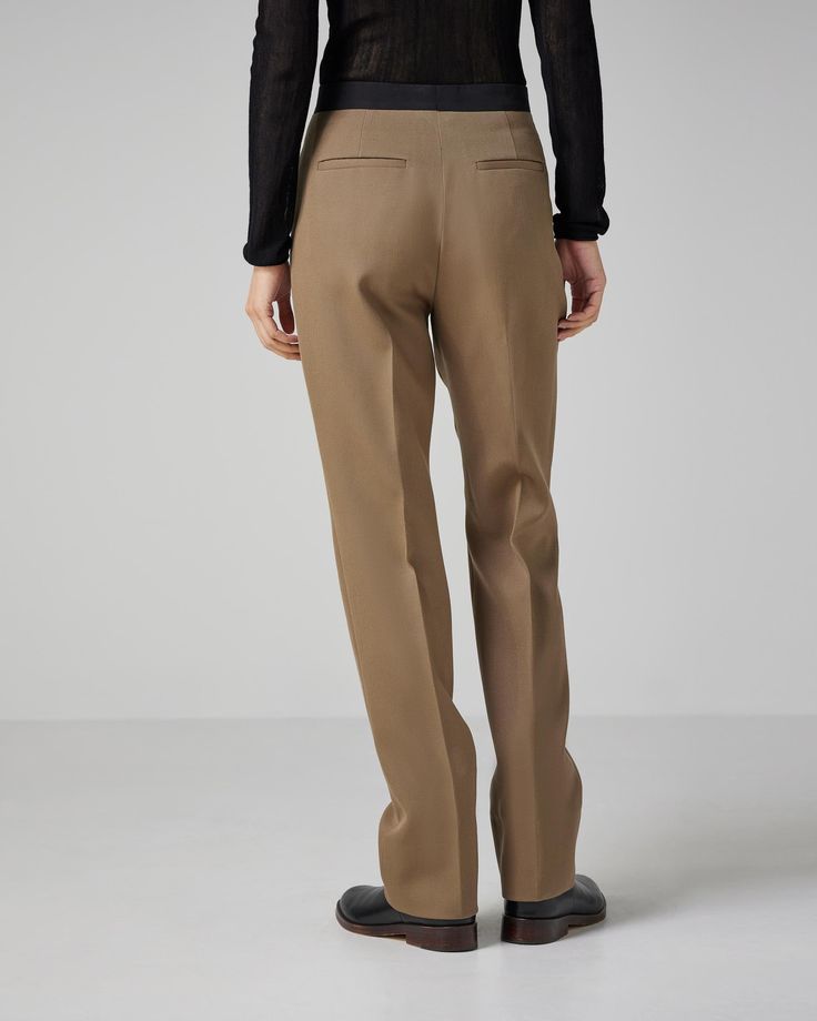 Straight leg trouser in wool twill with luxurious contrasting black silk faille extended waistband and inseam pockets. Classic Brown Bottoms For Office, Classic Brown Dress Pants For Office, Classic Brown Office Bottoms, Brown Pressed Crease Office Bottoms, Classic Brown Pants For Office, Luxury Brown Workwear Pants, Brown Straight Hem Dress Pants For Business Casual, Brown Office Pants With Pressed Crease, Tailored Brown Bottoms For Work