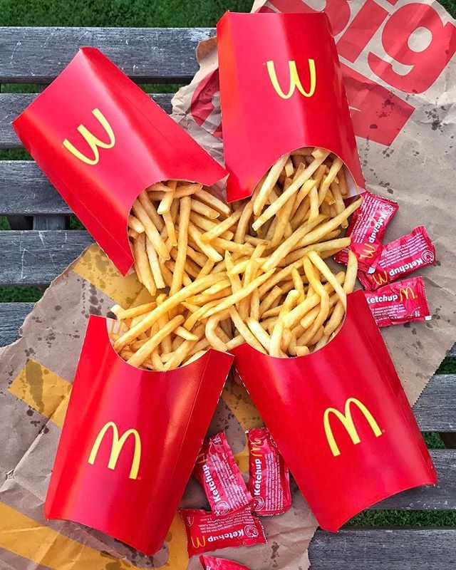 mcdonald's fries are wrapped in red paper and placed on top of each other