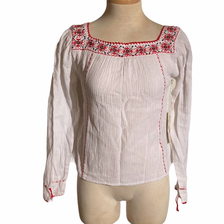 Free People Embroidered Blouse Nwt White Gauze Top With Red And Black Embroidery Detail Around The Neckline Red Decorative Stiching Down The Front And Back Of The Top Lightweight Material Great For Summer Boho/Bohemian Size M New With Tags Red Long Sleeve Cotton Embroidered Top, Red Embroidered Top With Embroidered Hem, White Folk Top With Embroidered Sleeves, White Folk Tops With Embroidered Sleeves, White Cotton Peasant Top With Embroidered Sleeves, White Long Sleeve Tops With Geometric Embroidery, White Fitted Folk Top, Folk Style Fitted White Embroidered Top, Fitted Folk White Top