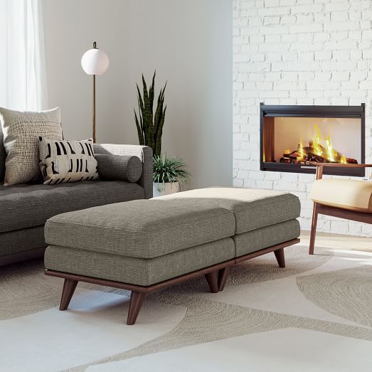 a living room with a couch, chair and fire place in the fireplace that is lit