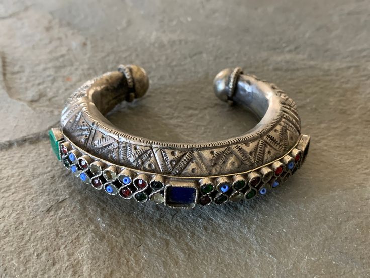 "Antique Yemen Afghan Morrocan Bedouin tribal cuff bracelet with so much detail! Beautiful designs in the silver itself and bright glass pieces that really pop. This piece is an antique so a few beads are missing as you can see from the photographs. This bracelet measures about 2 1/4\" across the inside and the opening on the bottom is about 1\". Total weight is a hefty 72 grams. Great showpiece or fun to wear --" Vintage Silver Beaded Bracelets For Festivals, Silver Artisan Beaded Bracelets For Festivals, Artisan Silver Beaded Bracelets For Festivals, Bohemian Silver Cuff Bracelet For Festival, Bohemian Silver Beads Bracelets For Festive Occasions, Silver Bohemian Beaded Bracelets For Festive Occasions, Bohemian Silver Beaded Bracelets For Festive Occasions, Bohemian Multicolor Bangle For Ceremonial Occasions, Multicolor Bohemian Bangle For Ceremonial Occasions