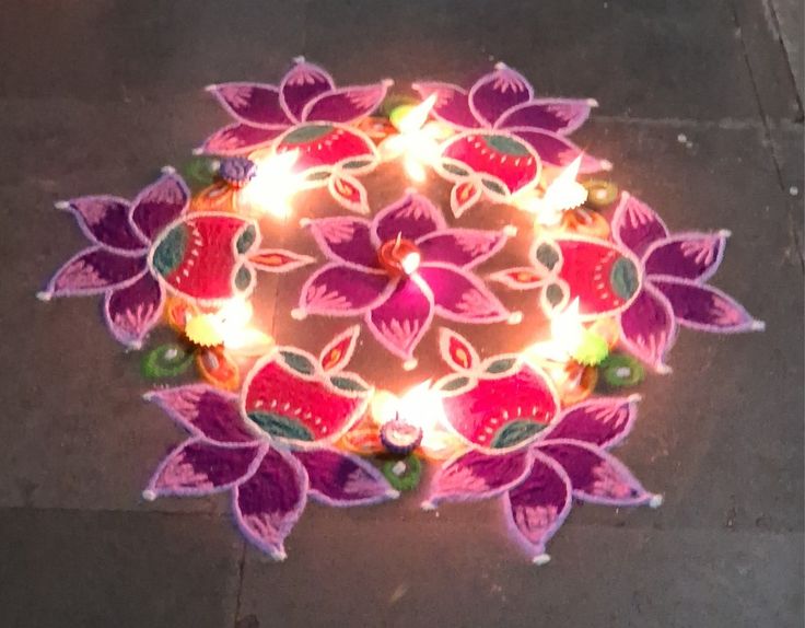 a decorated diya with lights on the ground