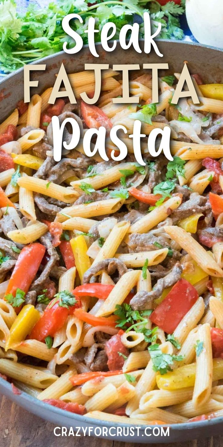 steak fajita pasta in a skillet on a wooden table