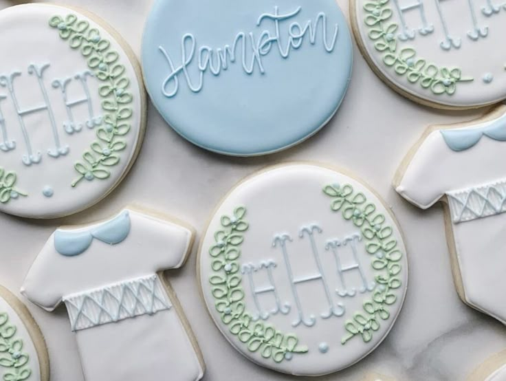 decorated cookies are arranged in the shape of sweaters and ones that say your name