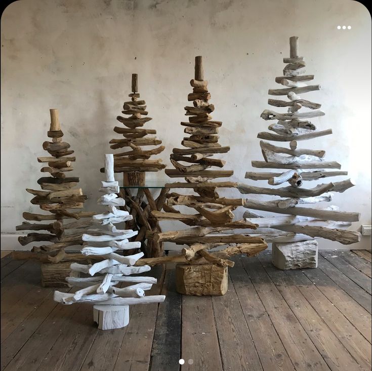 driftwood christmas trees are stacked on top of each other