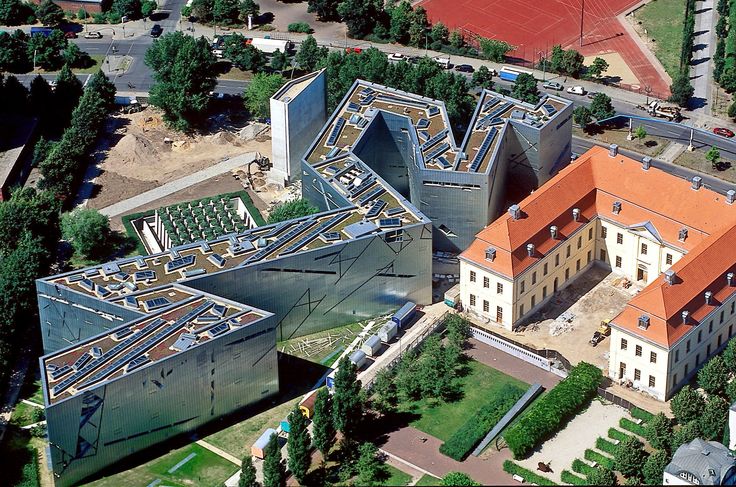 an aerial view of a large building with orange roof tiles on it's sides