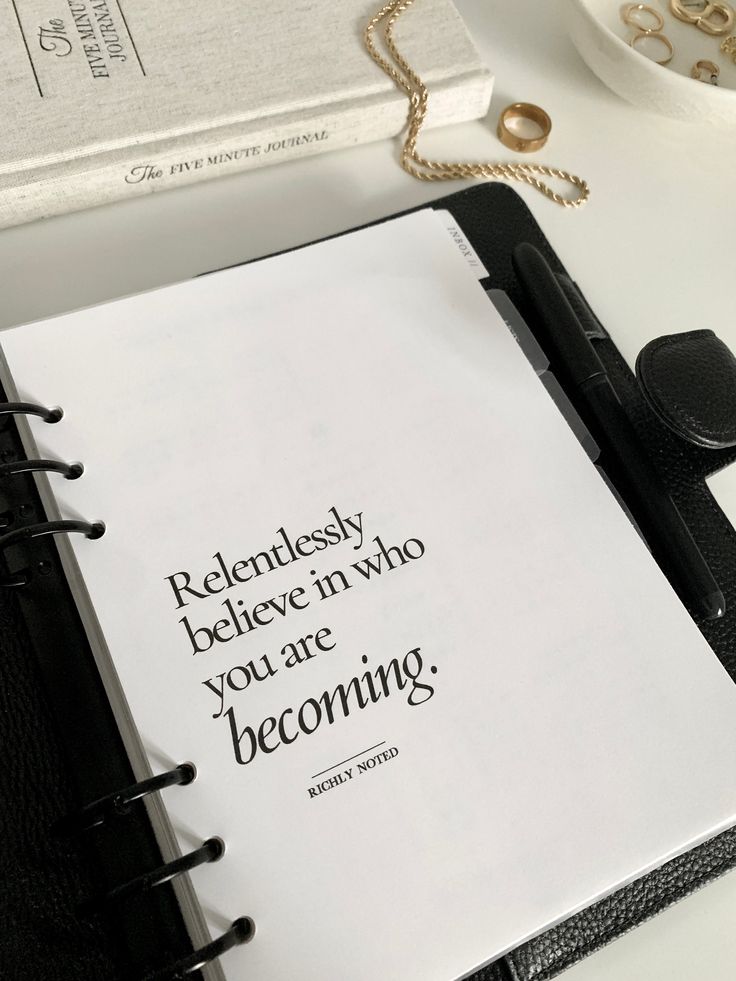 an open notebook with a quote on it